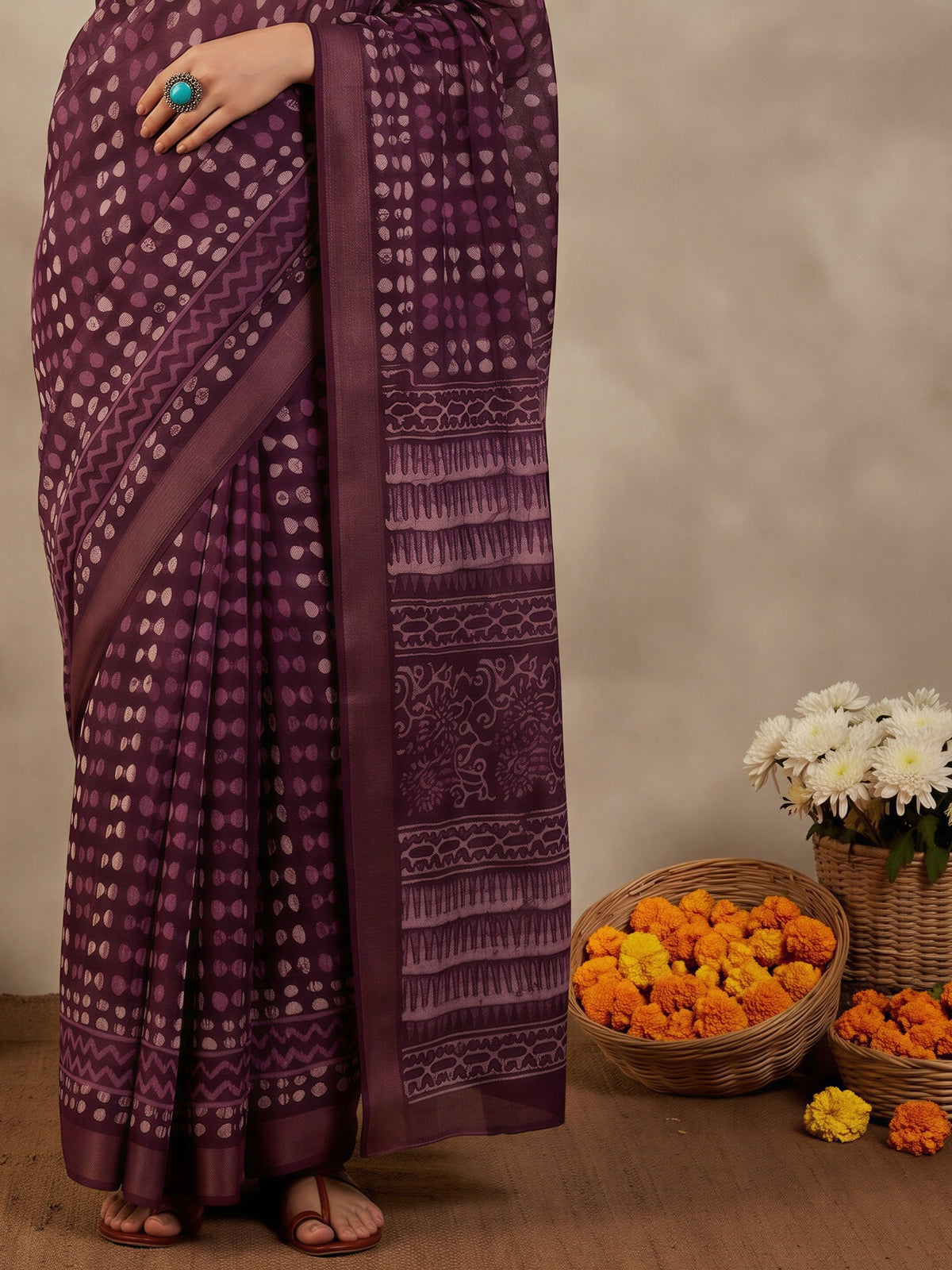 Pallu detail of violet cotton linen saree showing traditional indian motif work and zari border