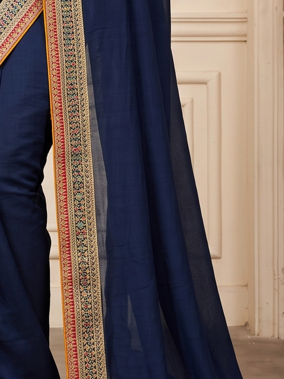 Pallu detail of teal blue vichitra silk saree showing clean solid-tone finish and embellished border