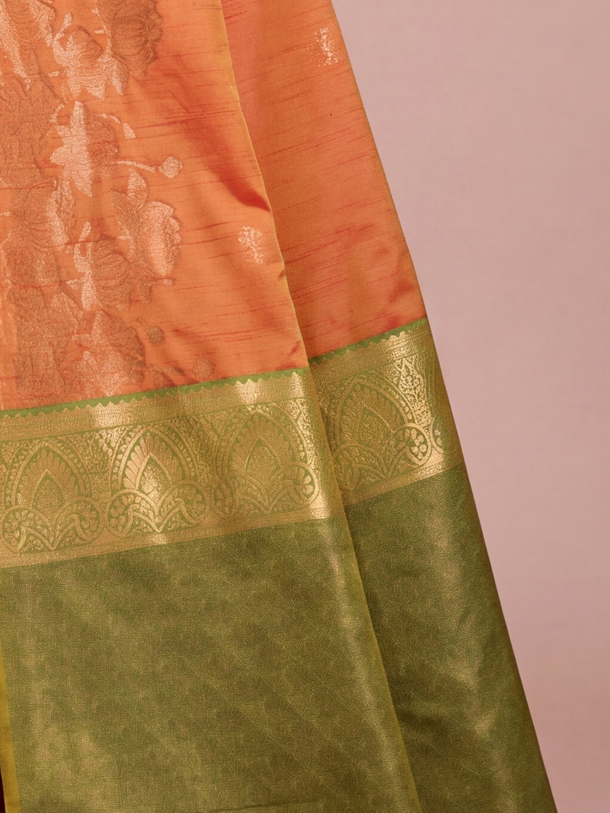Pallu detail of orange tussar silk saree showing traditional indian motif work and zari border