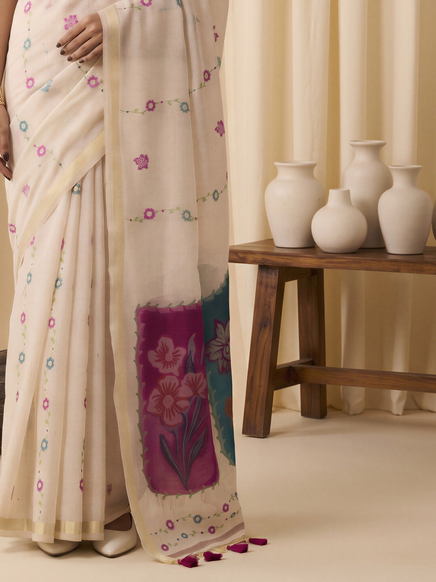 Pallu detail of off white cotton blend saree showing traditional indian motif work and zari border