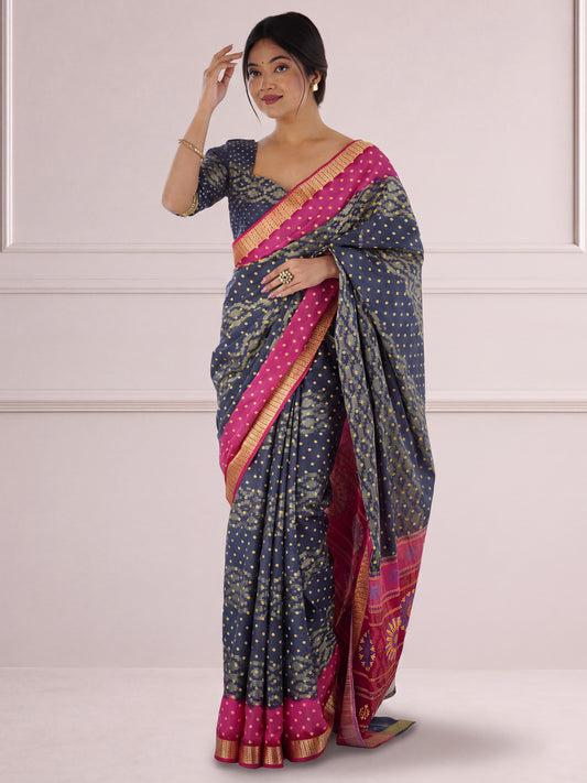 Woman wearing charcoal grey cotton saree with bandhani tie-dye dot work and charcoal grey blouse