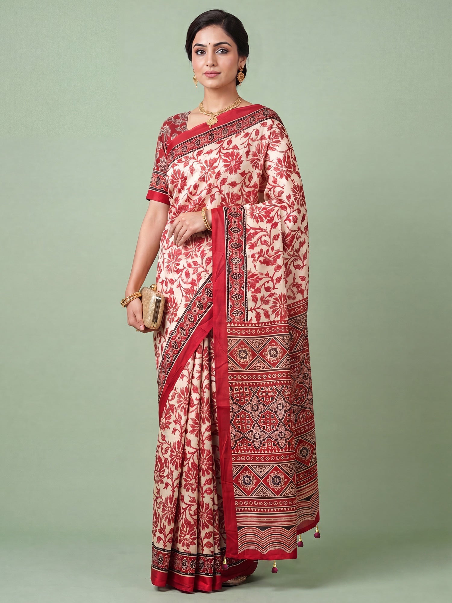 Woman wearing cream satin saree with ajrak block-print motif work and red blouse