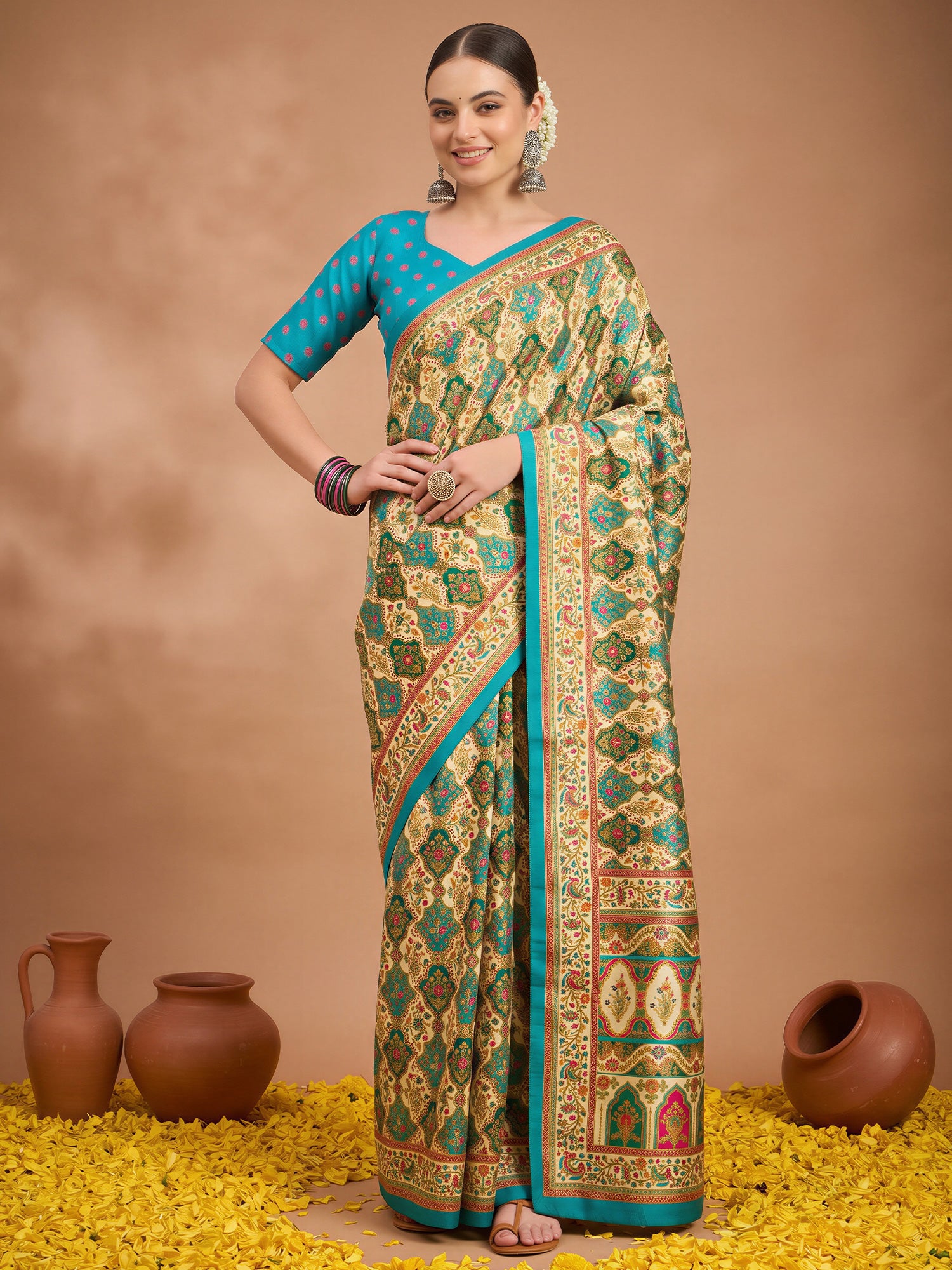 Woman wearing cream silk blend saree with metallic foil print work and light blue blouse