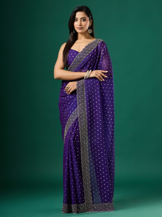 Woman wearing violet silk blend saree with ornamented surface design and violet blouse