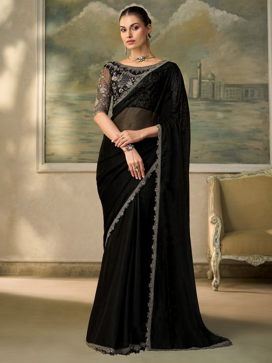 Woman wearing black chiffon saree with embroidered motif work and black blouse