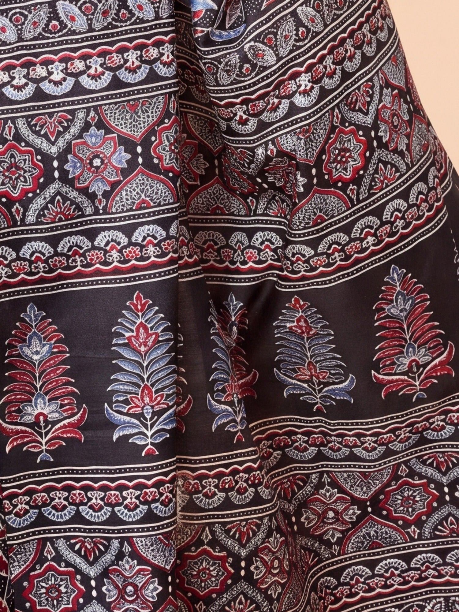 Pallu detail of black dola silk saree showing ajrak block-print motif work and solid border