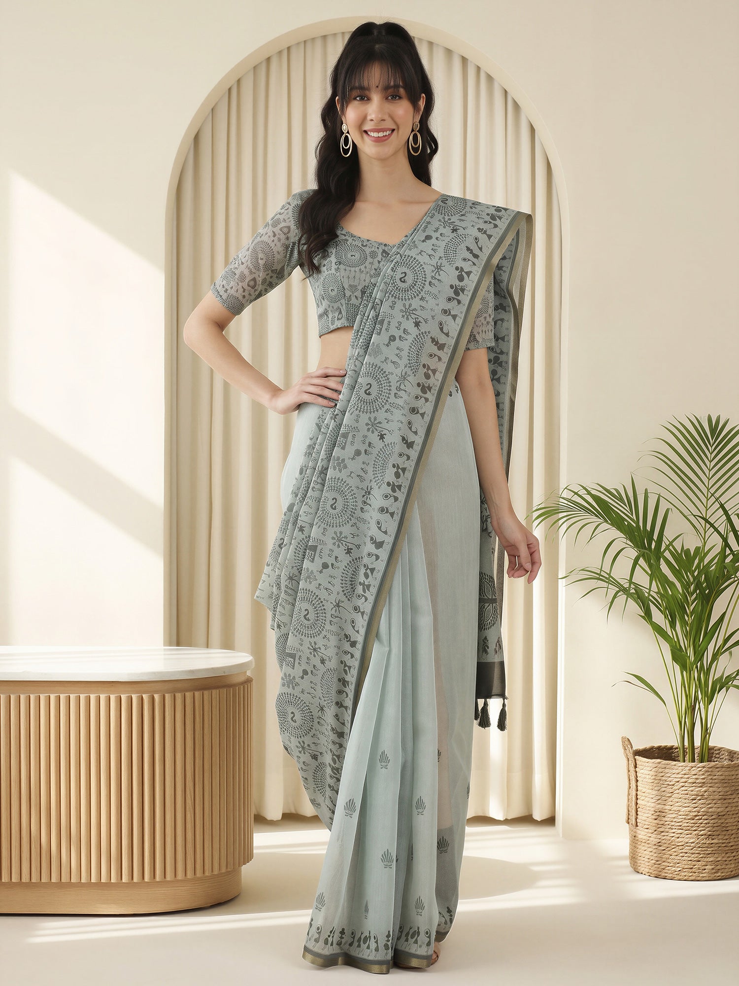 Woman wearing grey cotton linen saree with warli folk-art figures and grey blouse