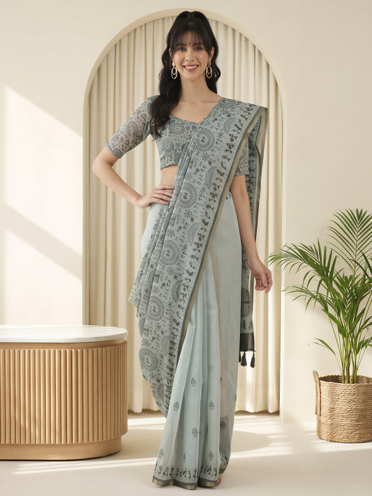 Woman wearing grey cotton linen saree with warli folk-art figures and grey blouse
