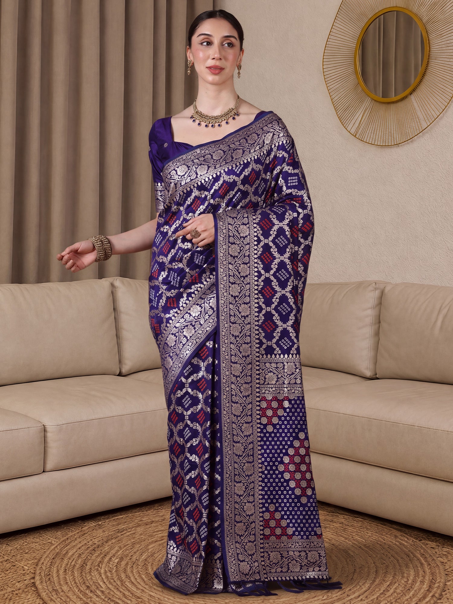 Woman wearing purple dola silk saree with bandhani tie-dye dot work and purple blouse