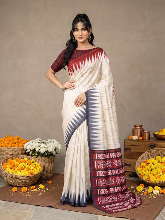 Woman wearing beige bhagalpuri silk saree with ikat resist-dyed pattern and red blouse