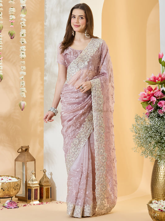 Woman wearing mauve organza saree with embroidered motif work and mauve blouse