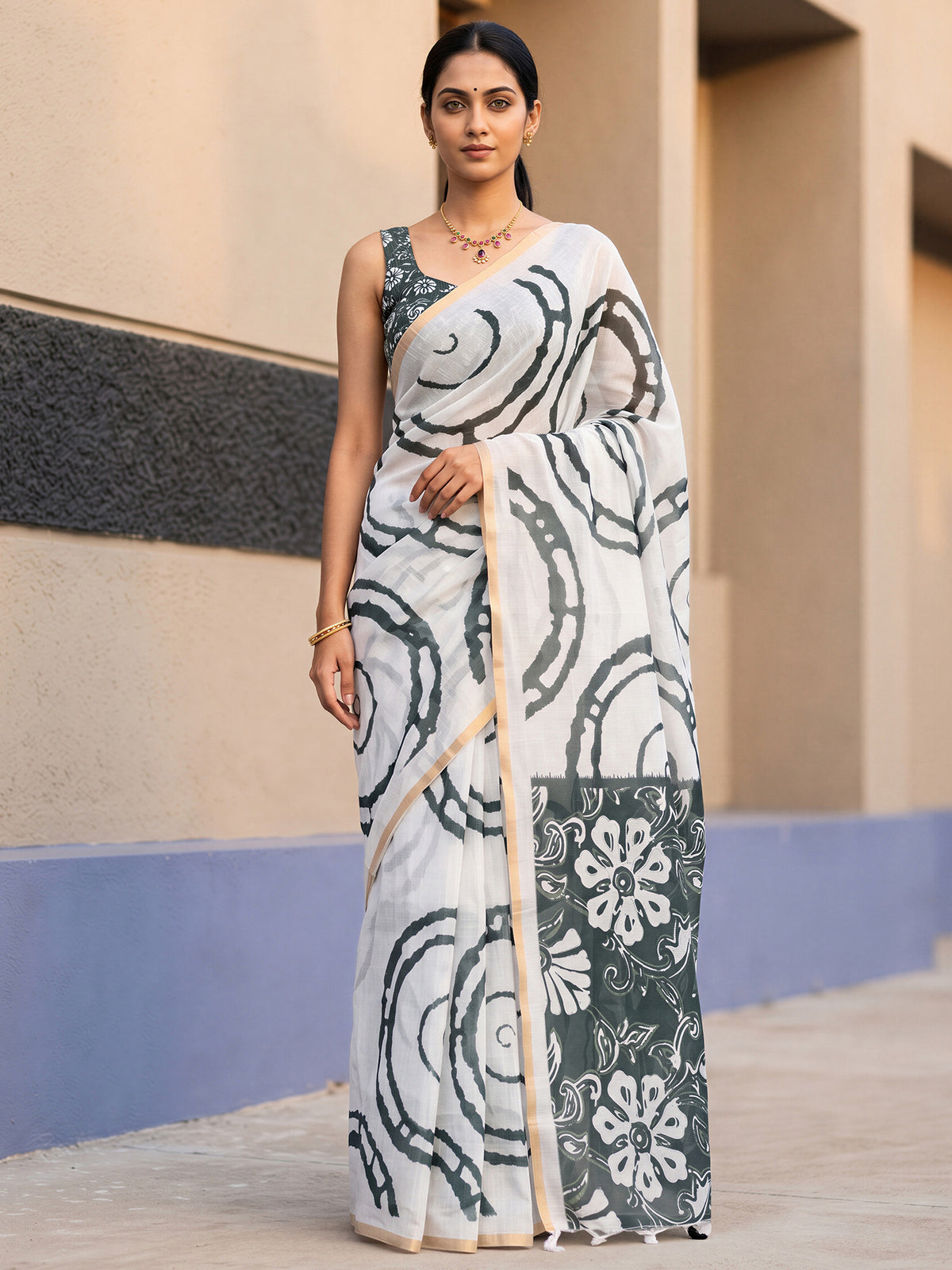 Woman wearing white cotton blend saree with shibori resist-dye pattern and black blouse