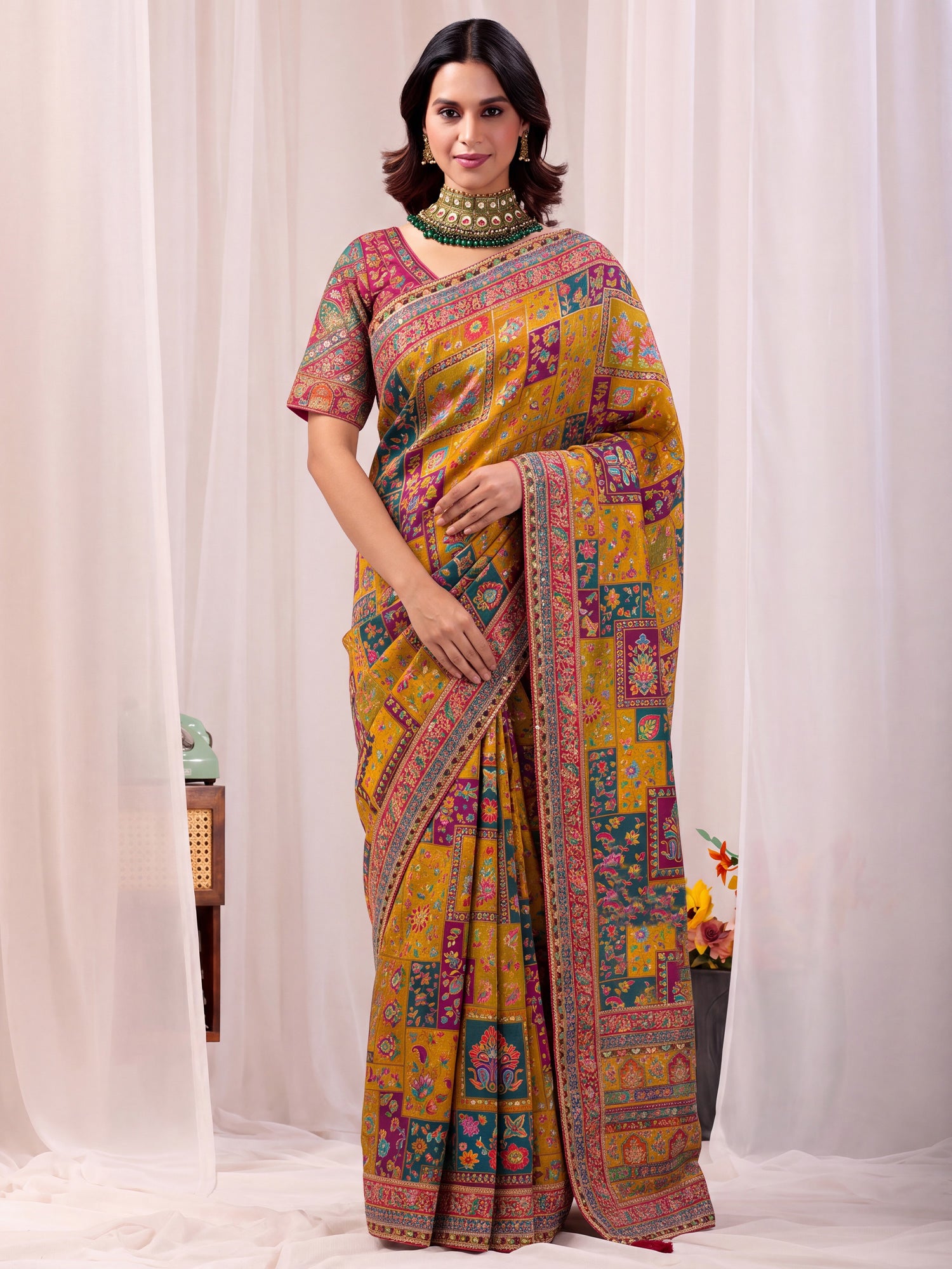 Woman wearing mustard silk blend saree with traditional indian motif work and pink blouse