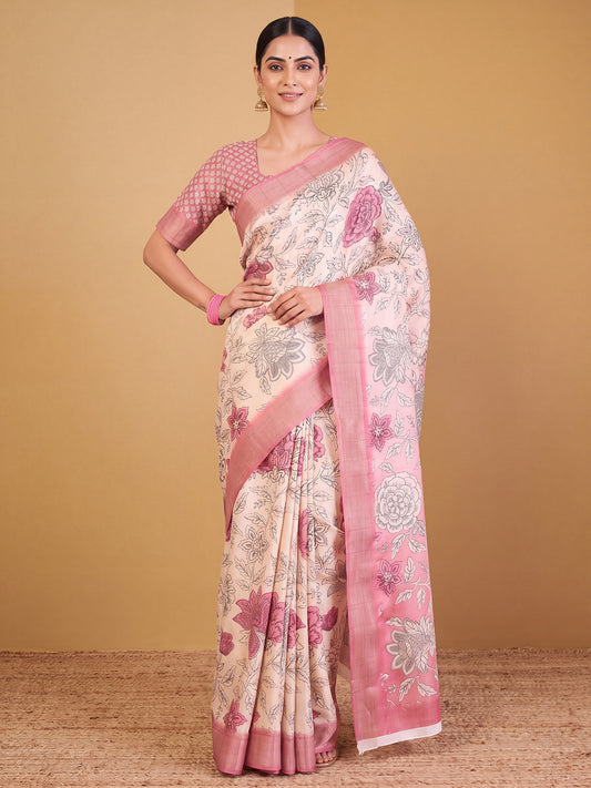 Woman wearing white satin silk saree with traditional indian motif work and pink blouse