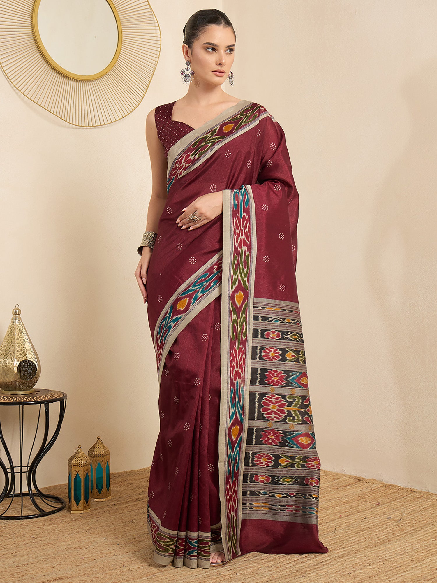 Woman wearing maroon bhagalpuri silk saree with ikat resist-dyed pattern and maroon blouse