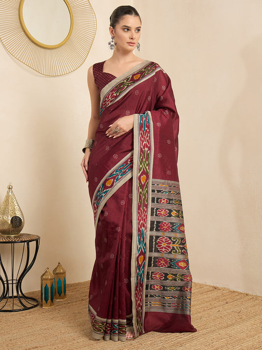 Woman wearing maroon bhagalpuri silk saree with ikat resist-dyed pattern and maroon blouse