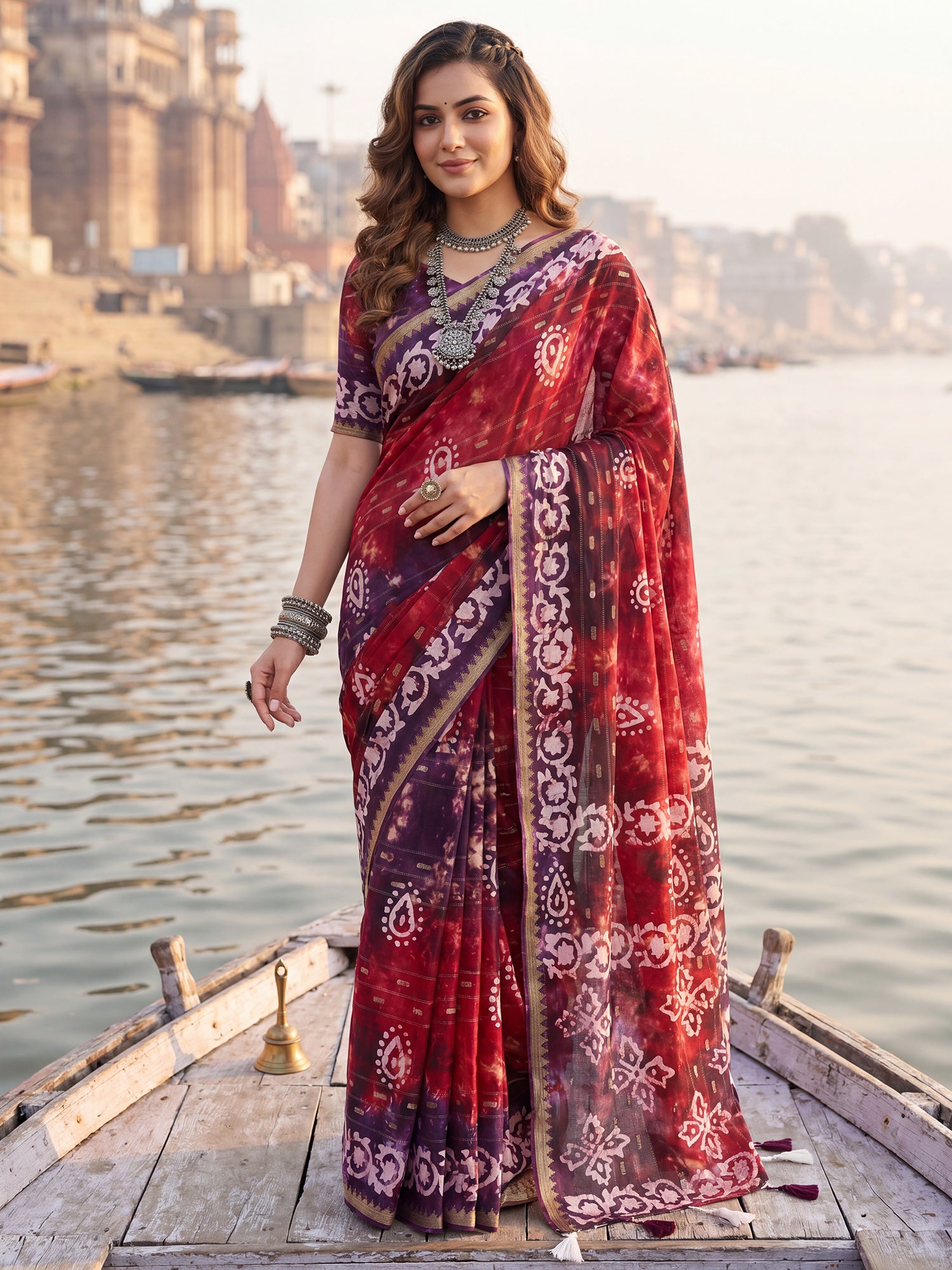 Woman wearing red cotton saree with shibori resist-dye pattern and purple blouse