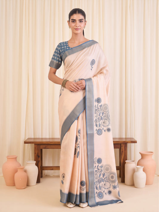 Woman wearing white satin silk saree with traditional indian motif work and blue blouse