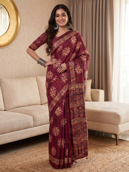 Woman wearing burgundy pure crepe saree with ajrak block-print motif work and burgundy blouse