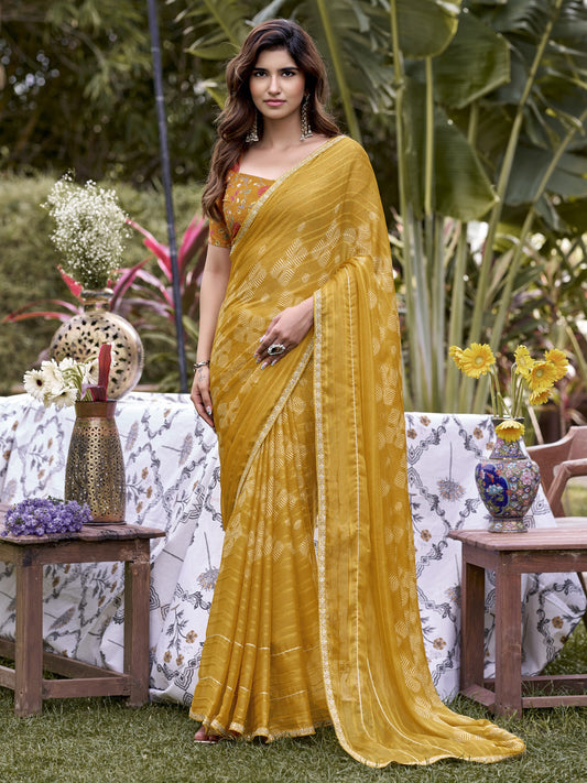 Woman wearing mustard chiffon saree with traditional indian motif work and mustard blouse