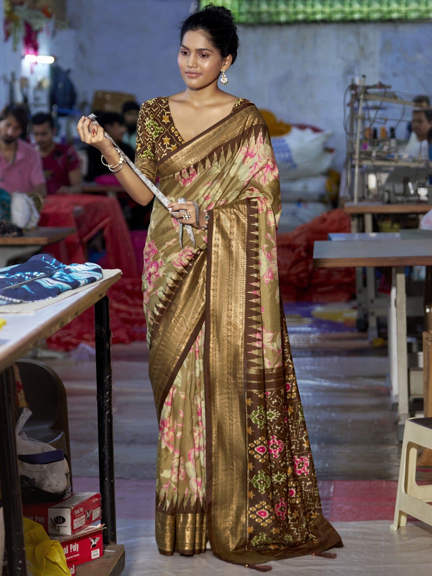 Woman wearing light brown tussar silk saree with ikat resist-dyed pattern and brown blouse
