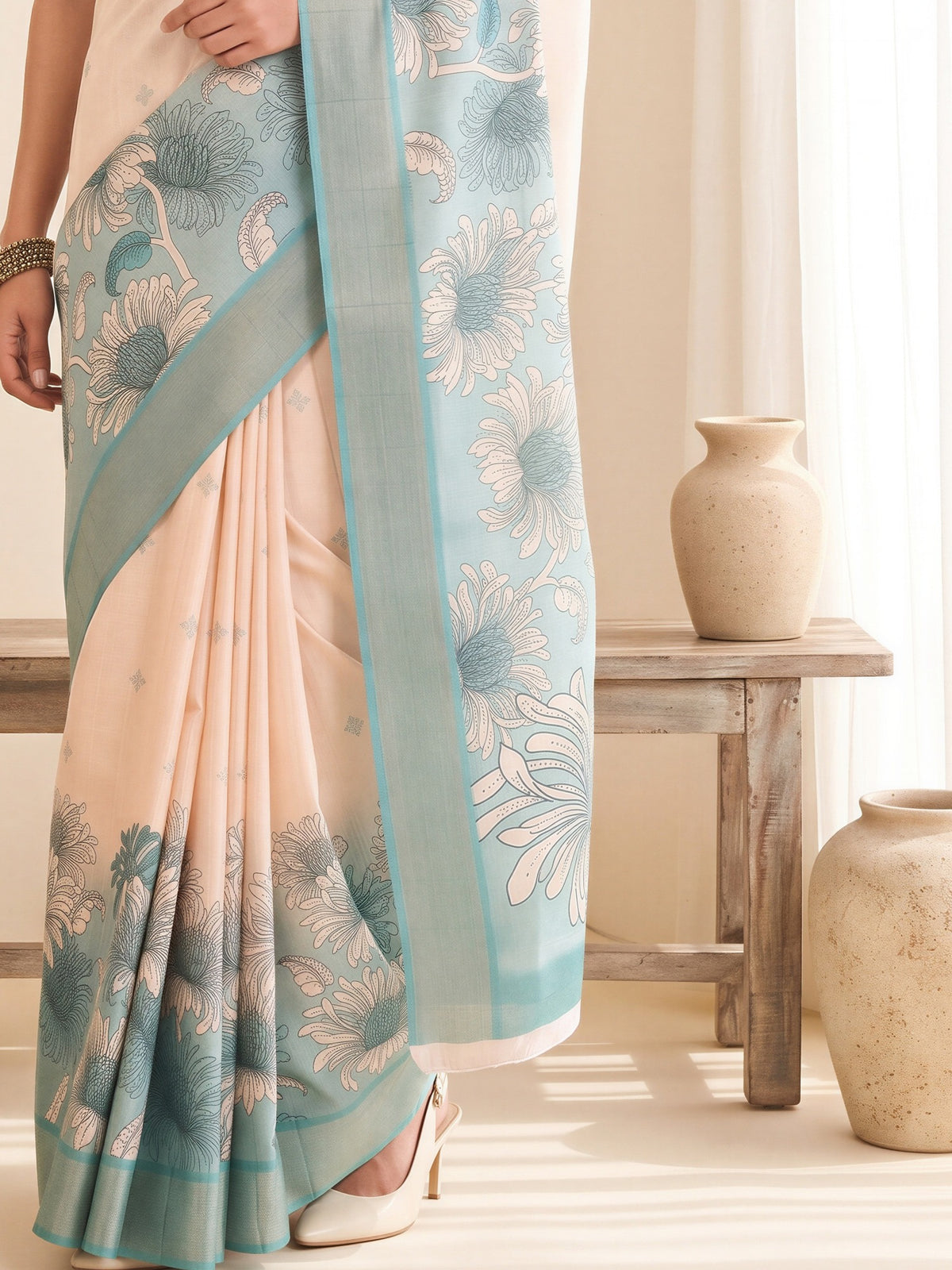 Pallu detail of white satin silk saree showing traditional indian motif work and printed border