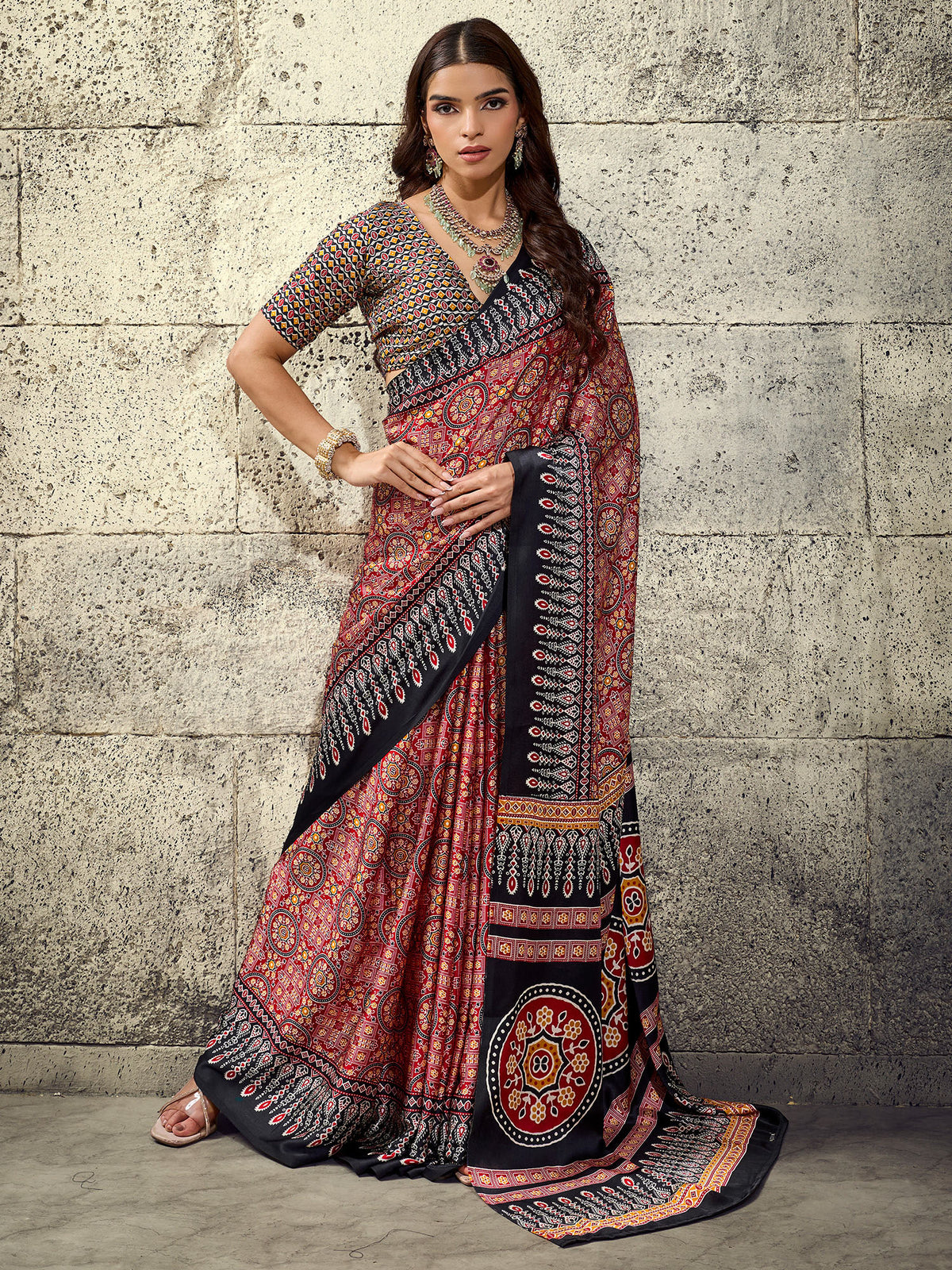 Woman wearing maroon satin saree with ajrak block-print motif work and black blouse
