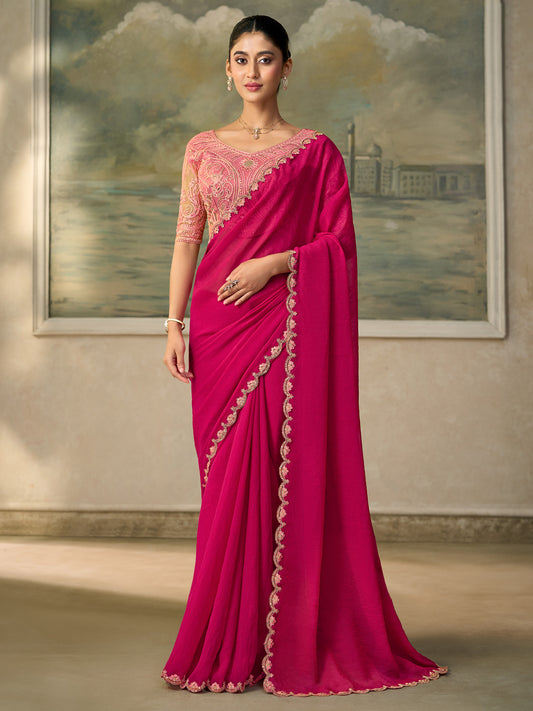 Woman wearing pink georgette saree with embroidered motif work and peach blouse