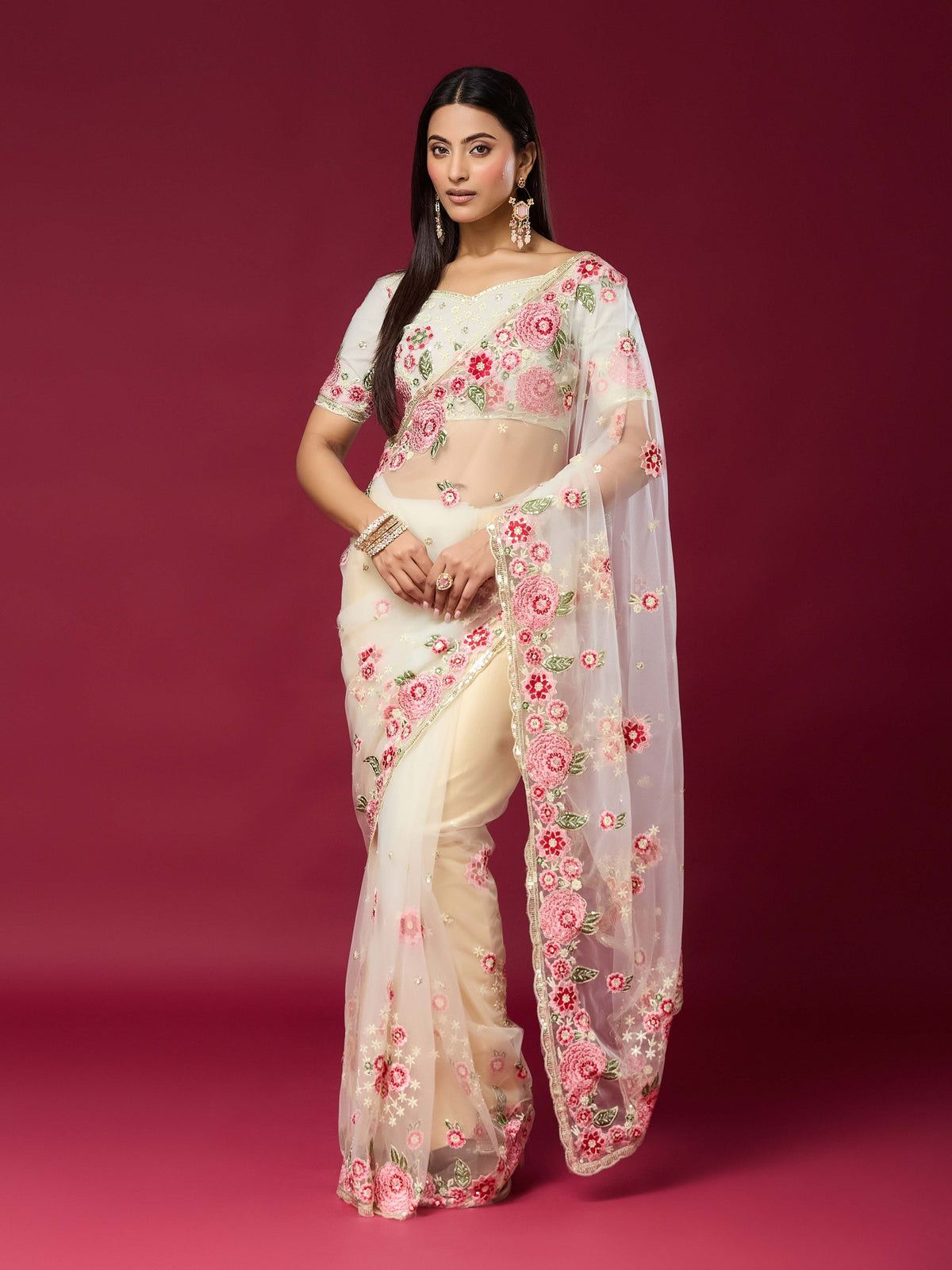 Woman wearing off white net saree with embroidered motif work and off white blouse