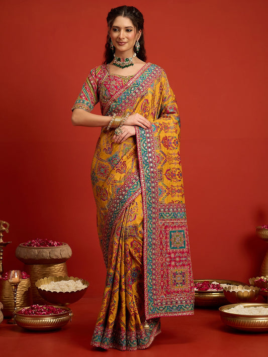 Woman wearing mustard silk blend saree with traditional indian motif work and pink blouse