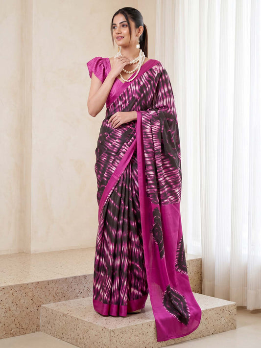 Woman wearing magenta crepe saree with shibori resist-dye pattern and magenta blouse