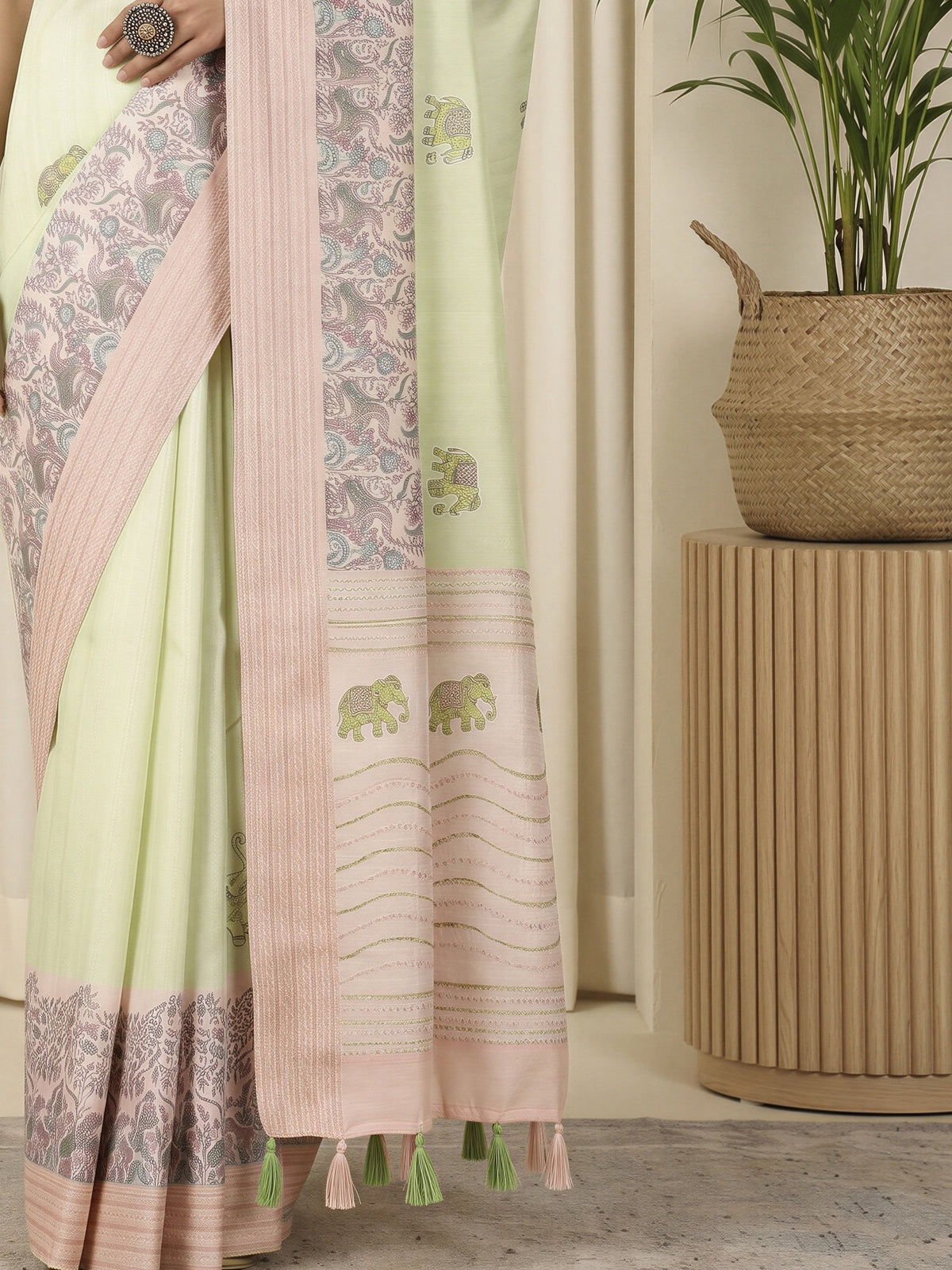Pallu detail of light green silk blend saree showing traditional indian motif work and embroidered border
