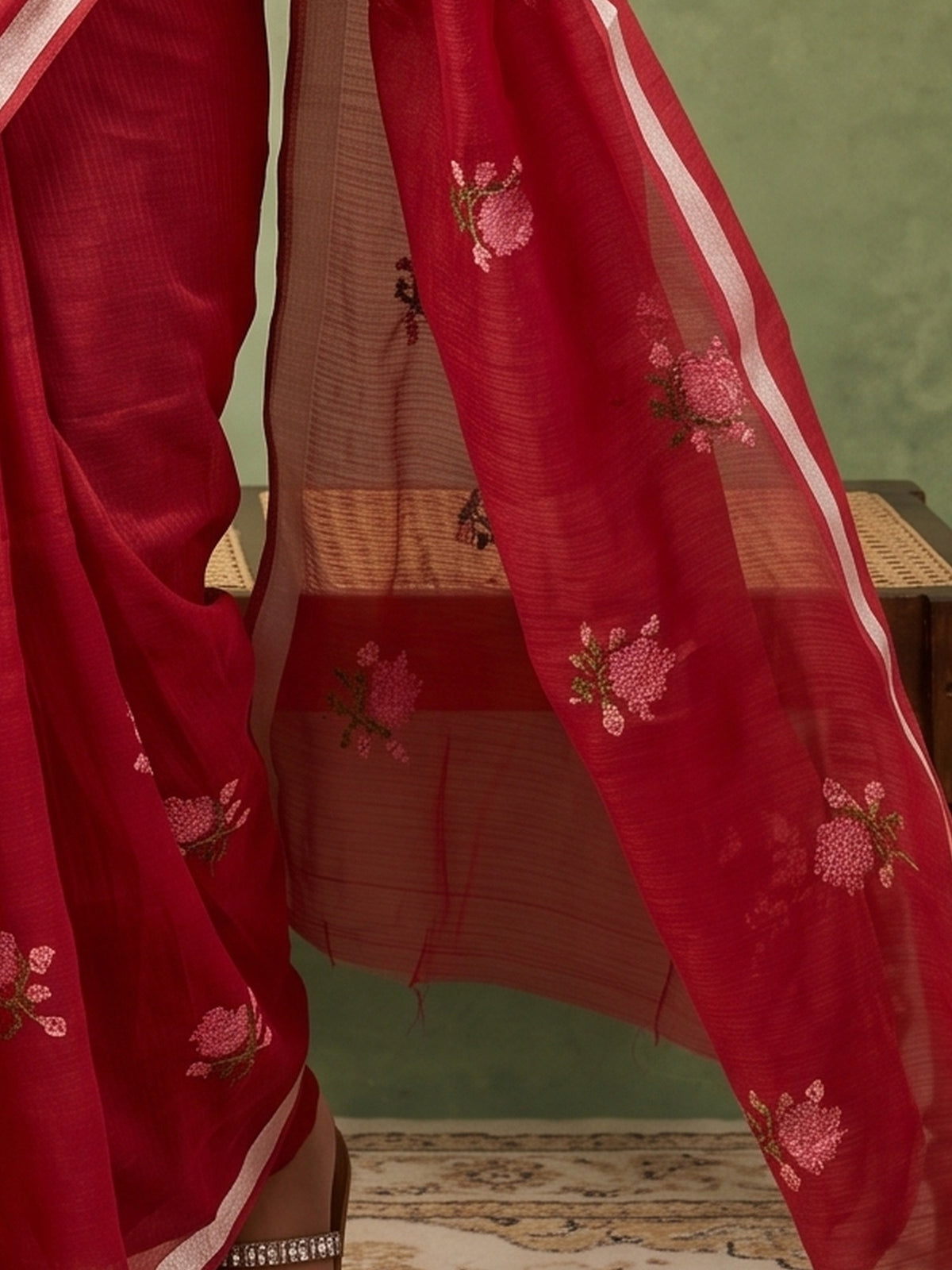 Pallu detail of red kota doria cotton saree showing embroidered motif work and zari border