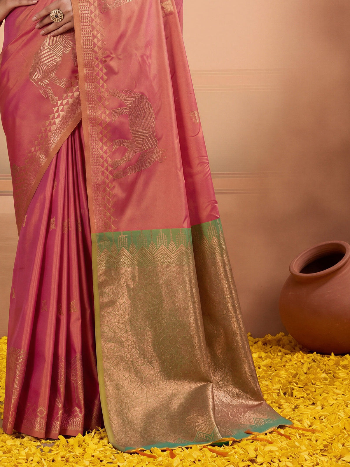 Pallu detail of pink silk saree showing animal-print design and zari border