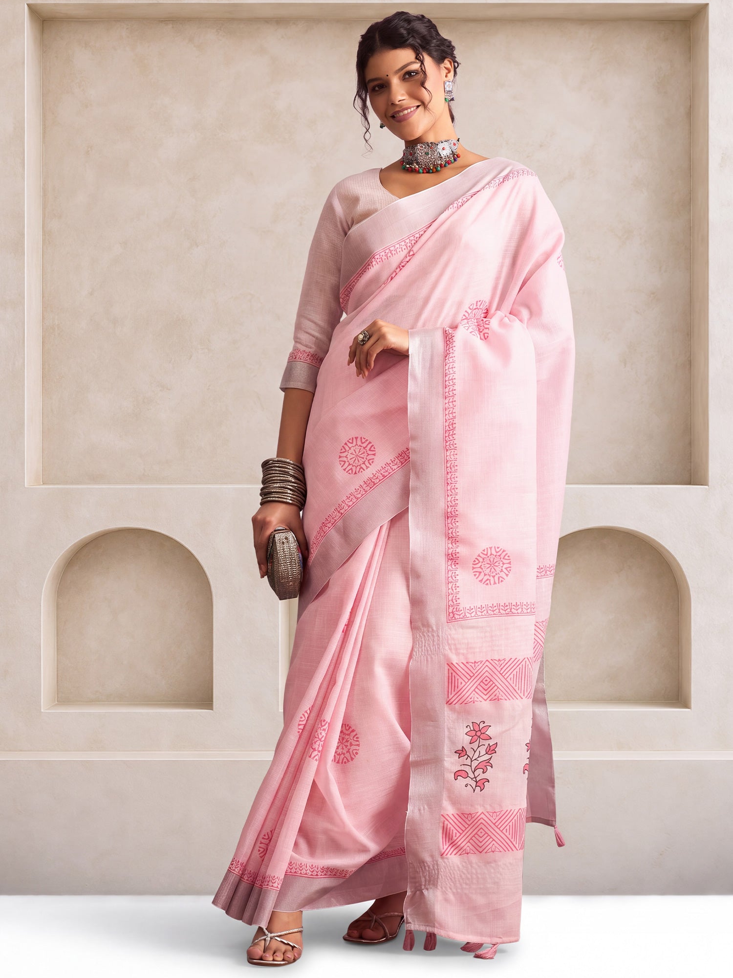 Woman wearing pink linen saree with bagh block-print motif work and pink blouse
