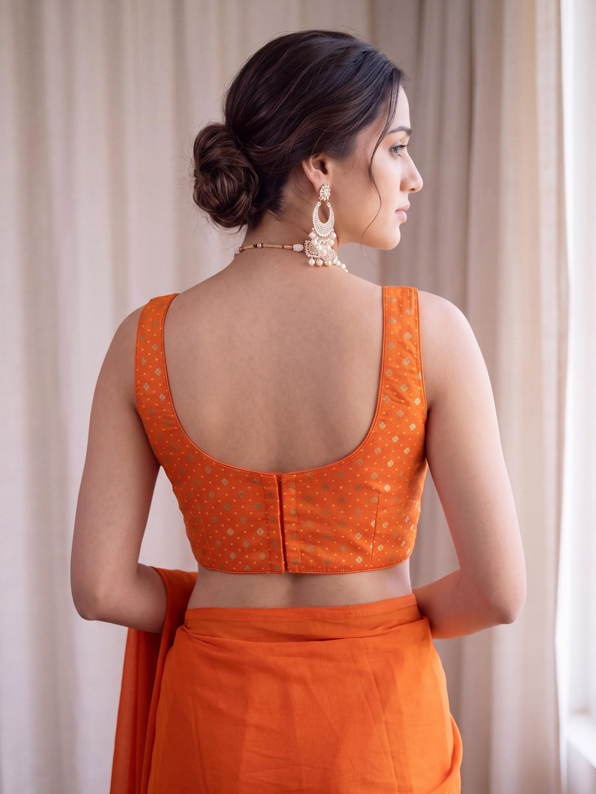 Orange zari woven silk blend sleeveless readymade saree blouse with round neck view 3