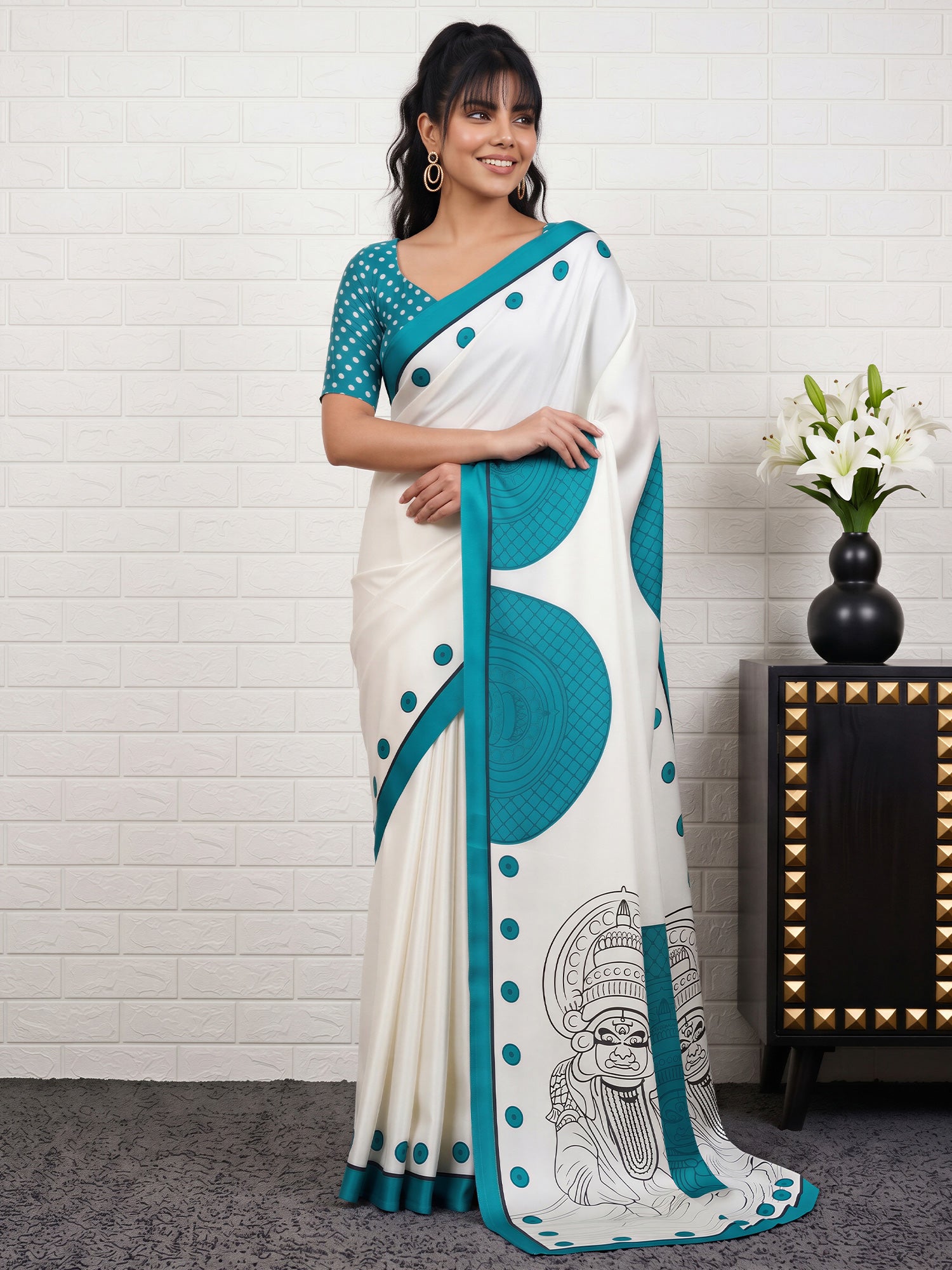 Woman wearing white satin saree with traditional indian motif work and light blue blouse