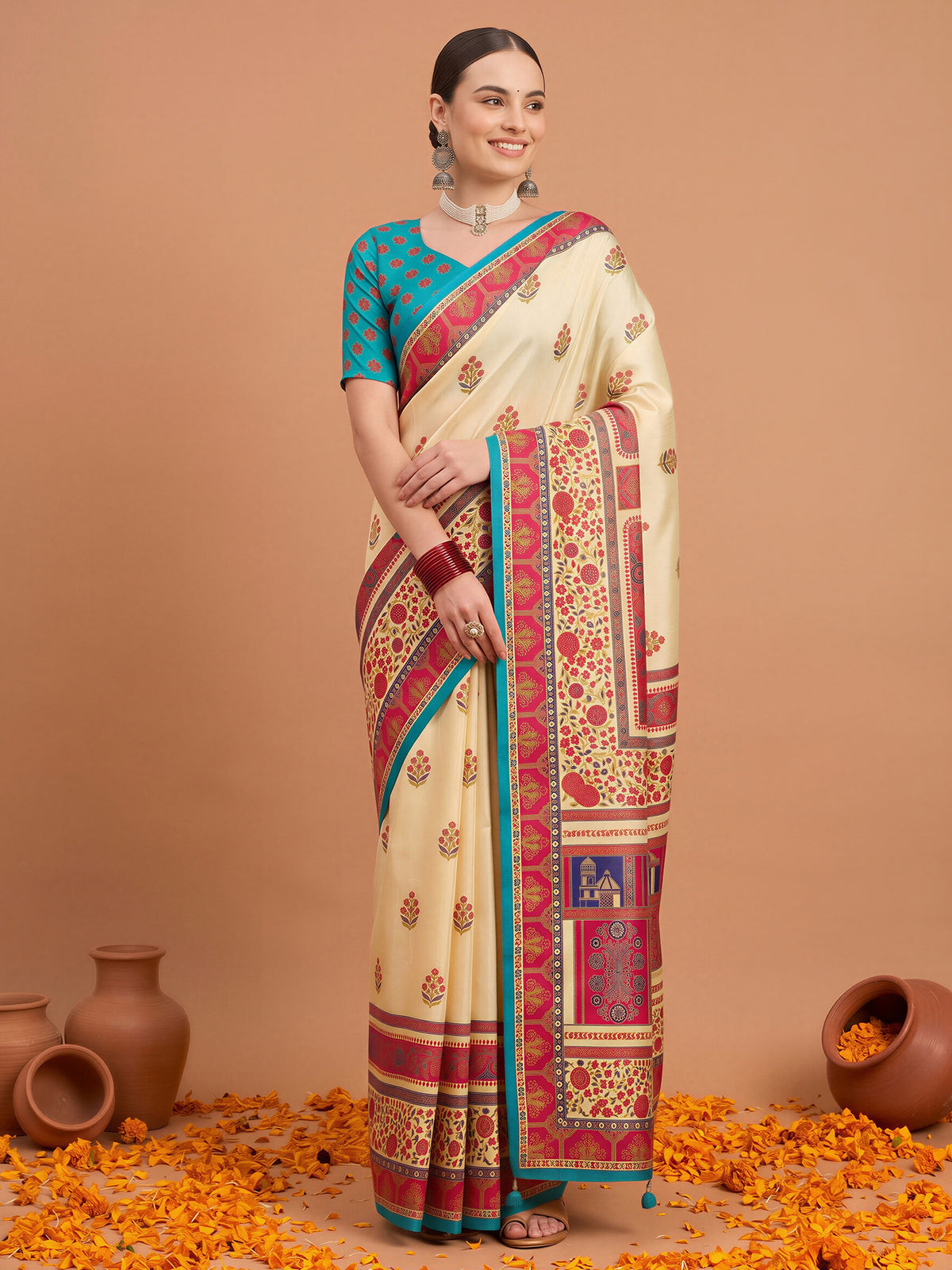Woman wearing cream silk blend saree with metallic foil print work and light blue blouse