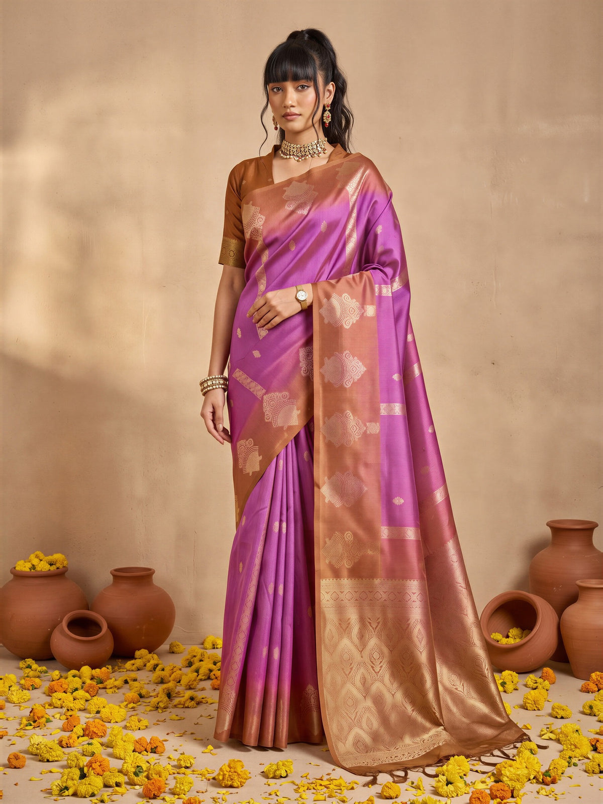 Woman wearing purple cotton blend saree with ornamented surface design and bronze blouse