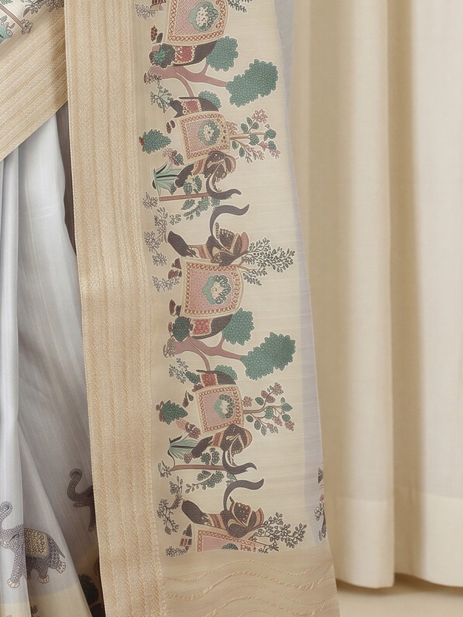 Pallu detail of grey silk blend saree showing traditional indian motif work and embroidered border