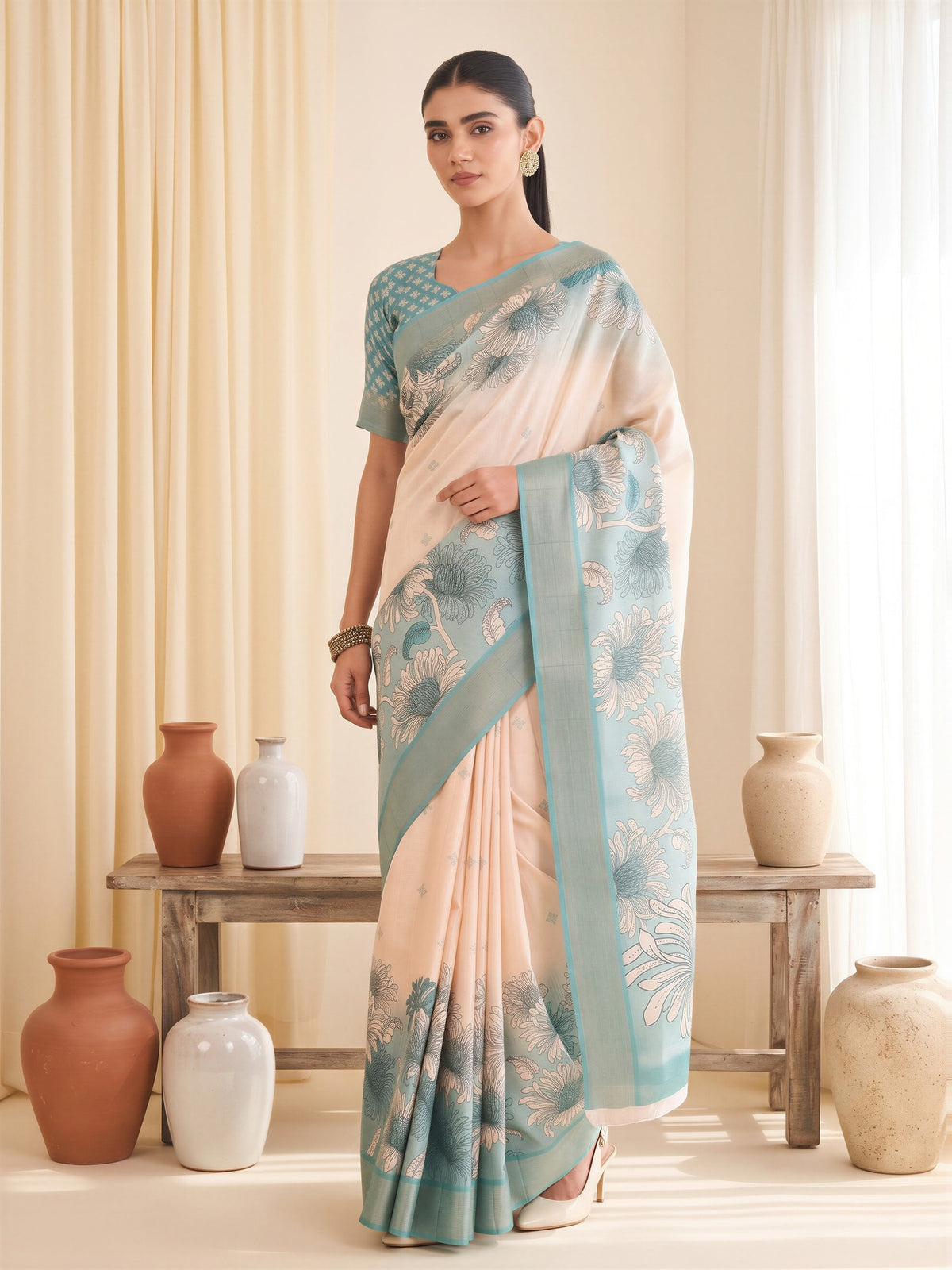 Woman wearing white satin silk saree with traditional indian motif work and light blue blouse