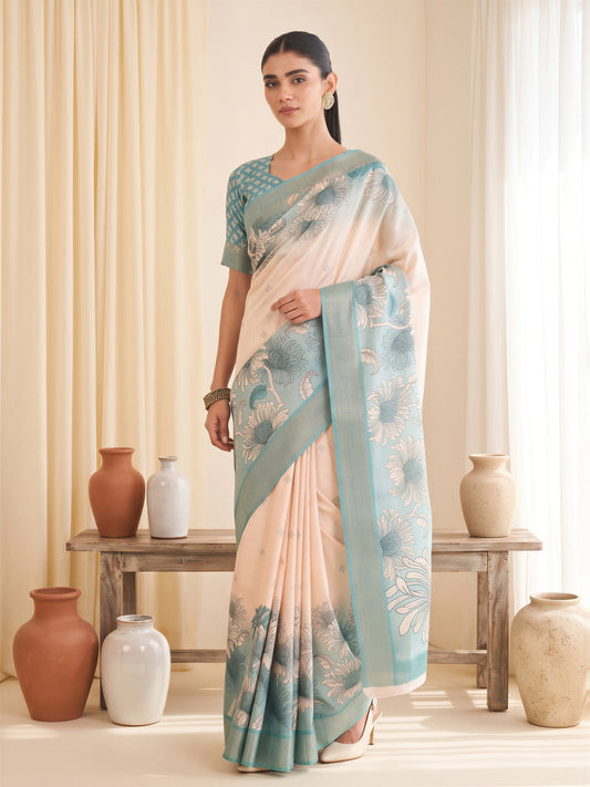 Woman wearing white satin silk saree with traditional indian motif work and light blue blouse