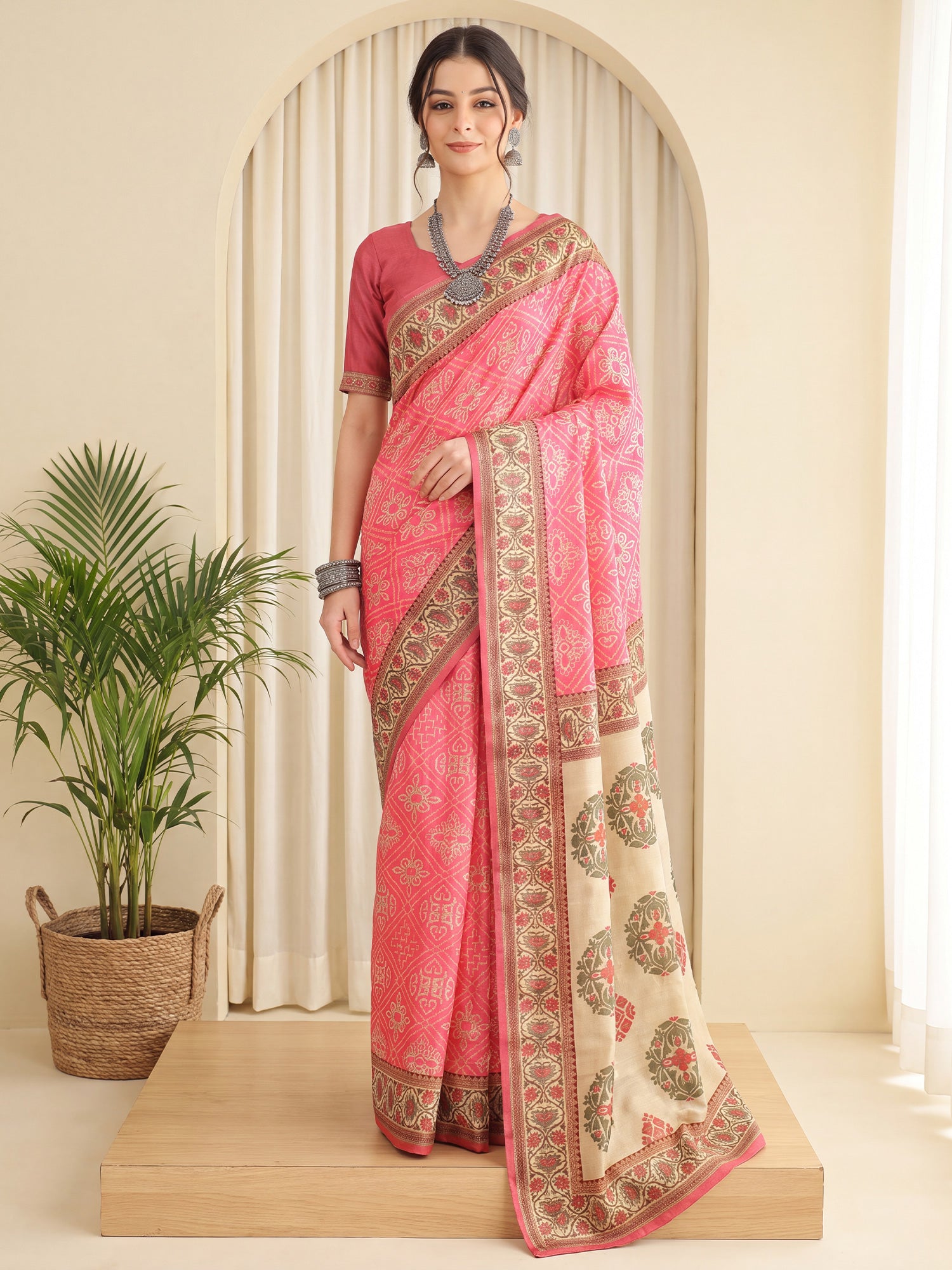 Woman wearing peach silk blend saree with traditional indian motif work and peach blouse