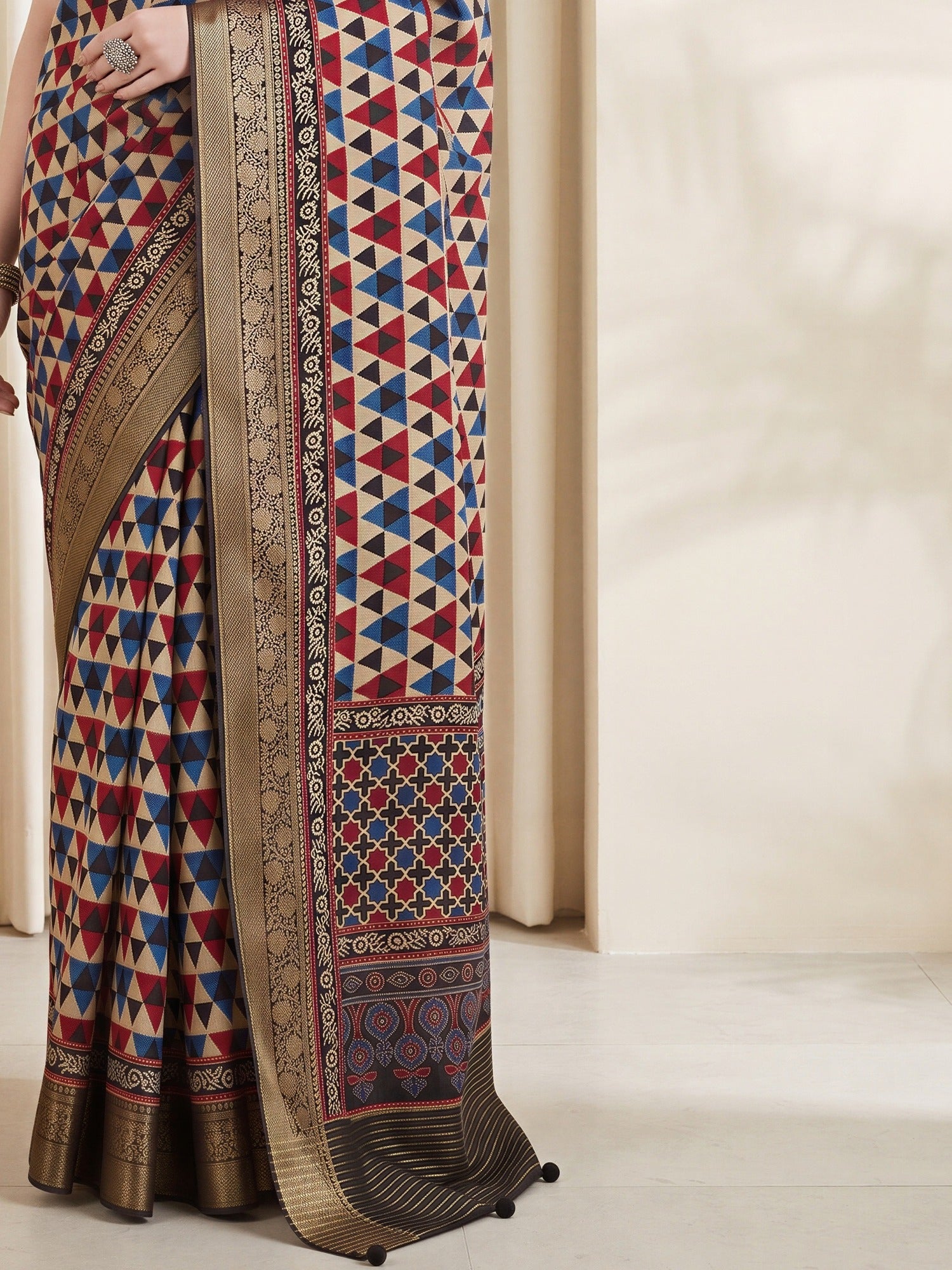 Pallu detail of beige viscose silk saree showing geometric pattern design and zari border