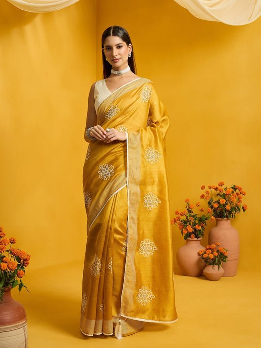 Woman wearing mustard cotton blend saree with embroidered motif work and mustard blouse