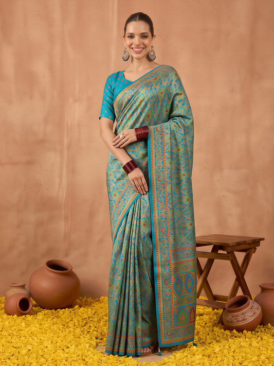 Woman wearing teal blue silk blend saree with metallic foil print work and teal blue blouse