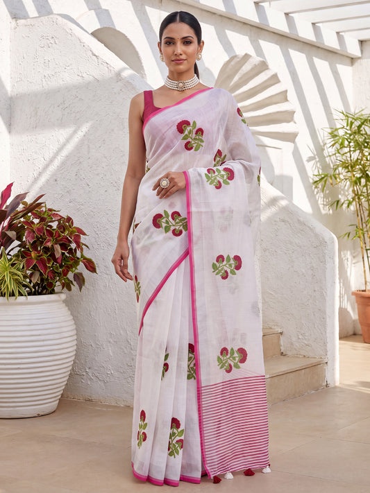Woman wearing white cotton linen saree with all-over floral design and pink blouse
