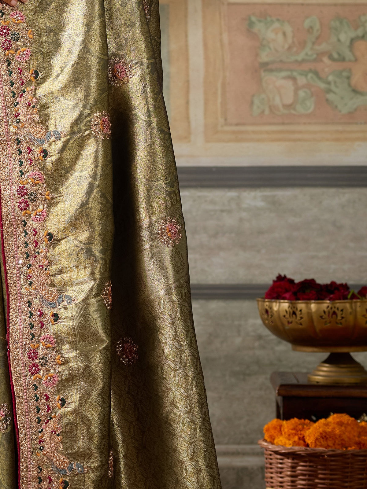 Pallu detail of olive silk blend saree showing ornamented surface design and embellished border