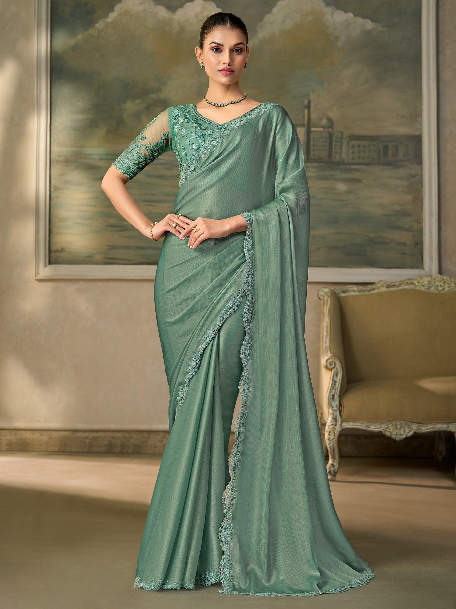 Woman wearing light blue chiffon saree with embroidered motif work and light blue blouse