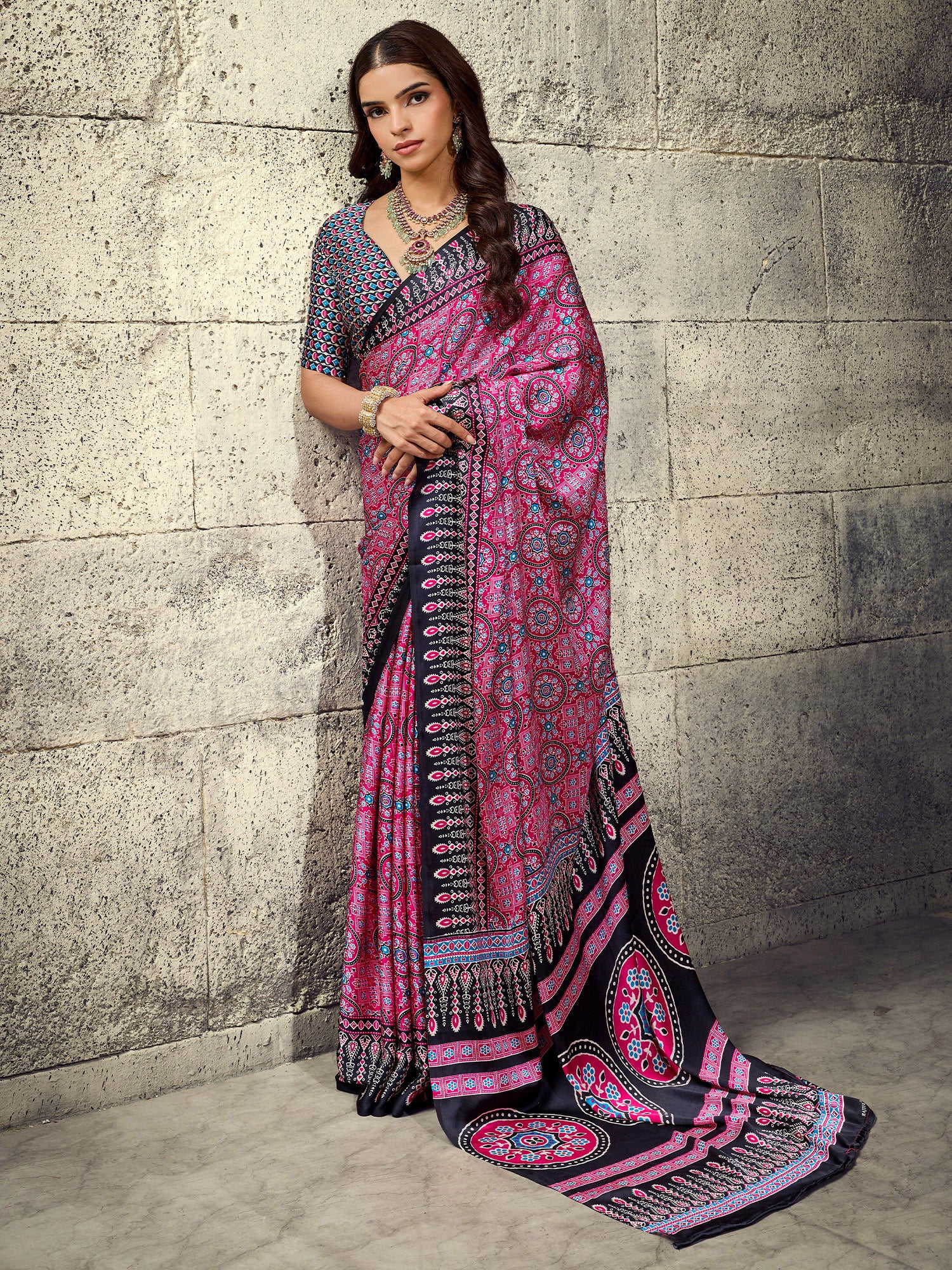 Woman wearing pink satin saree with ajrak block-print motif work and black blouse